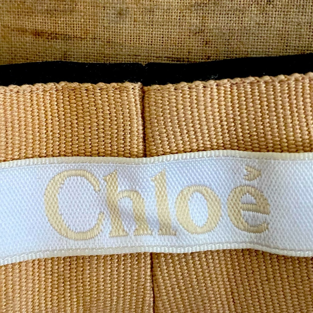 Black, very high split in front and back, beige inside detail